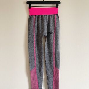 Nike leggings showcase a sleek gray base with vibrant pink accents size small